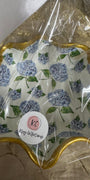 Decorative paper with floral design and gold border, wrapped in clear plastic with a visible brand label.