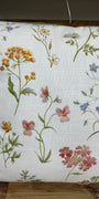 Floral-patterned pillow on a wooden surface