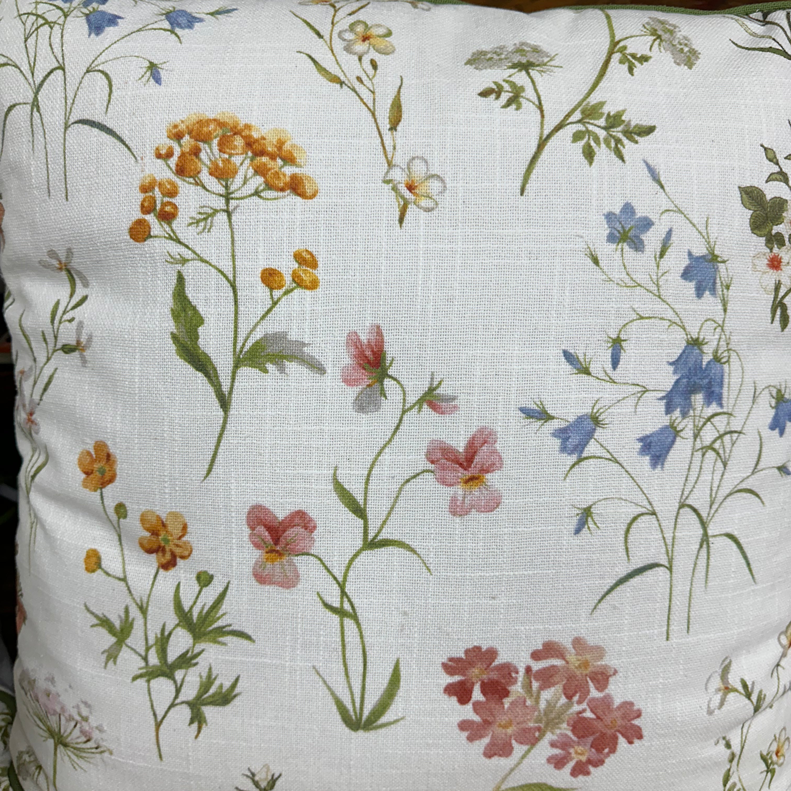 Floral-patterned pillow on a wooden surface