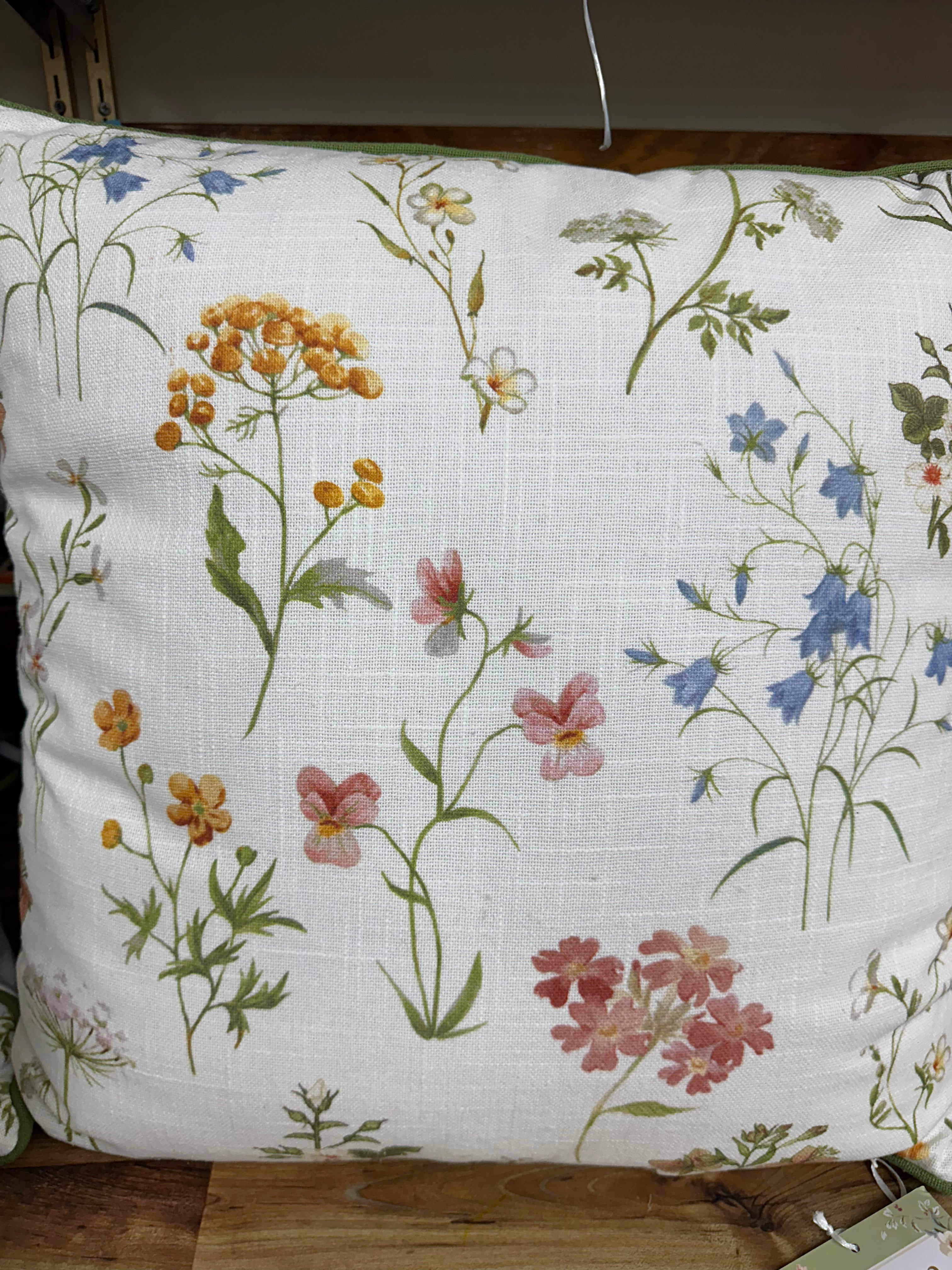 Floral-patterned pillow on a wooden surface