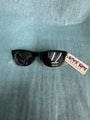 Black sunglasses with a tag on a gray background