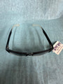 Black eyeglass frame with a tag on a gray background