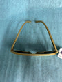 Gold-framed sunglasses on a blue textured background