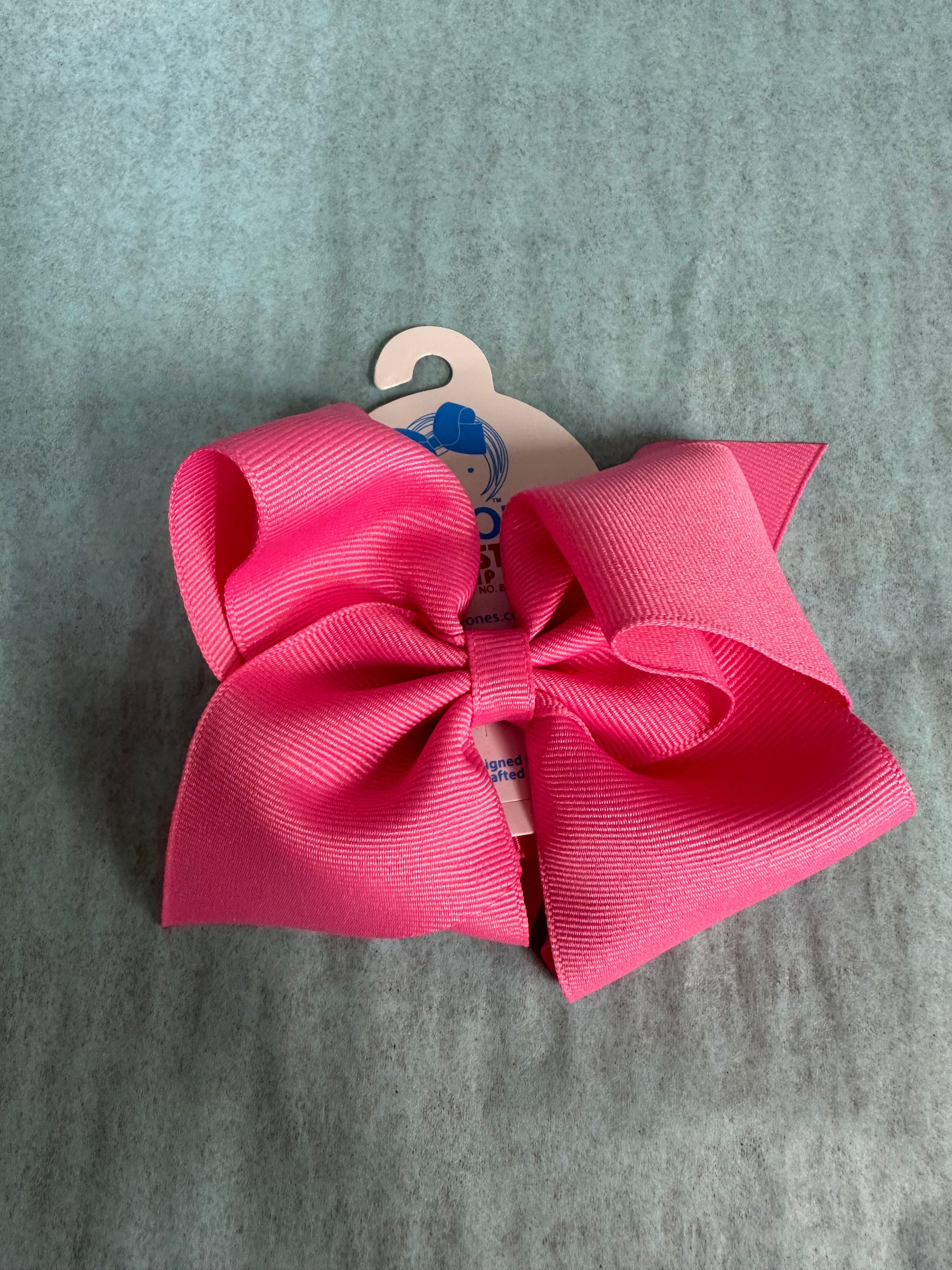 Pink hair bow on a gray background