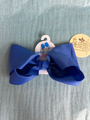Blue hair bow with a tag on a gray background