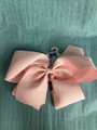 Pink bow on a textured green background