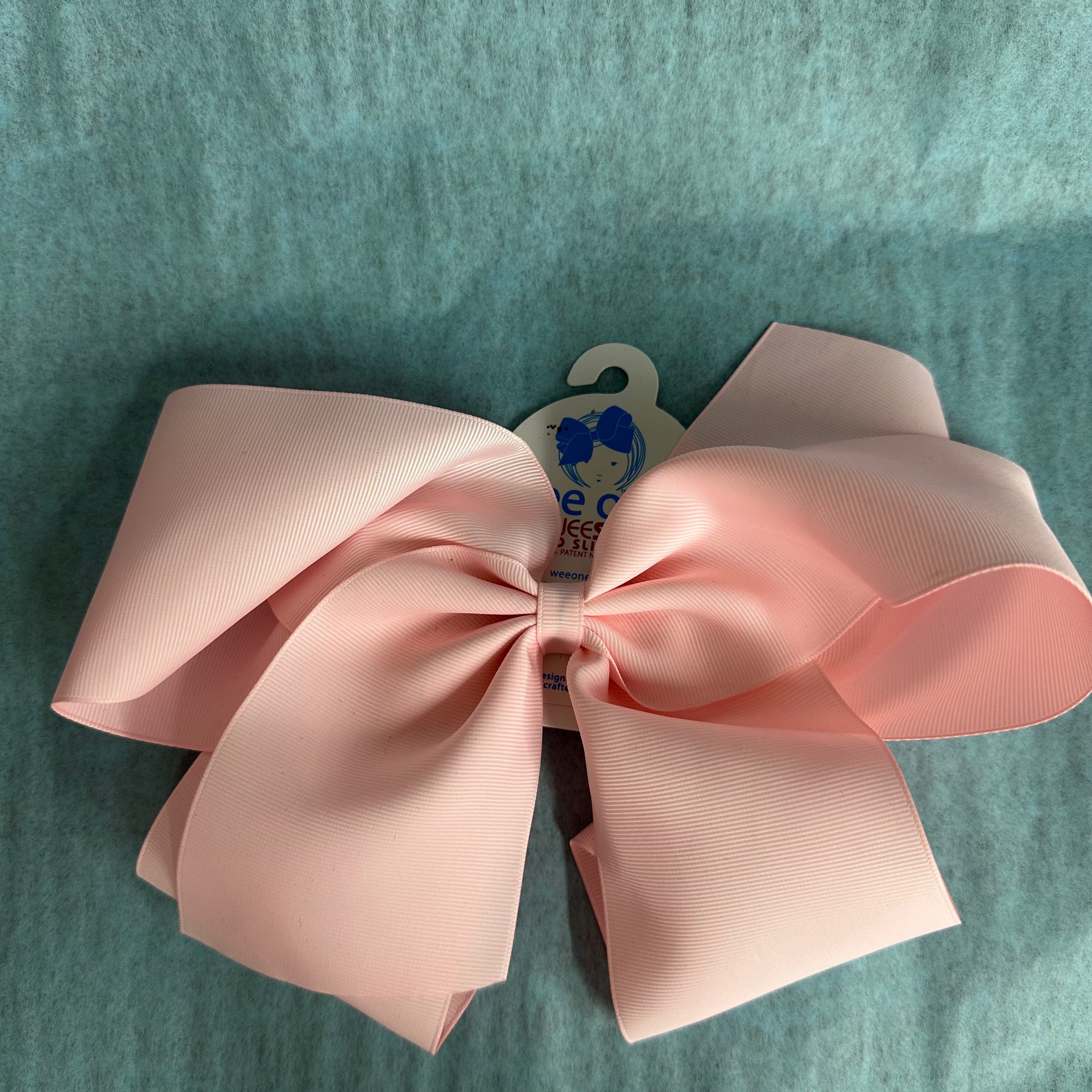 Pink bow on a textured green background