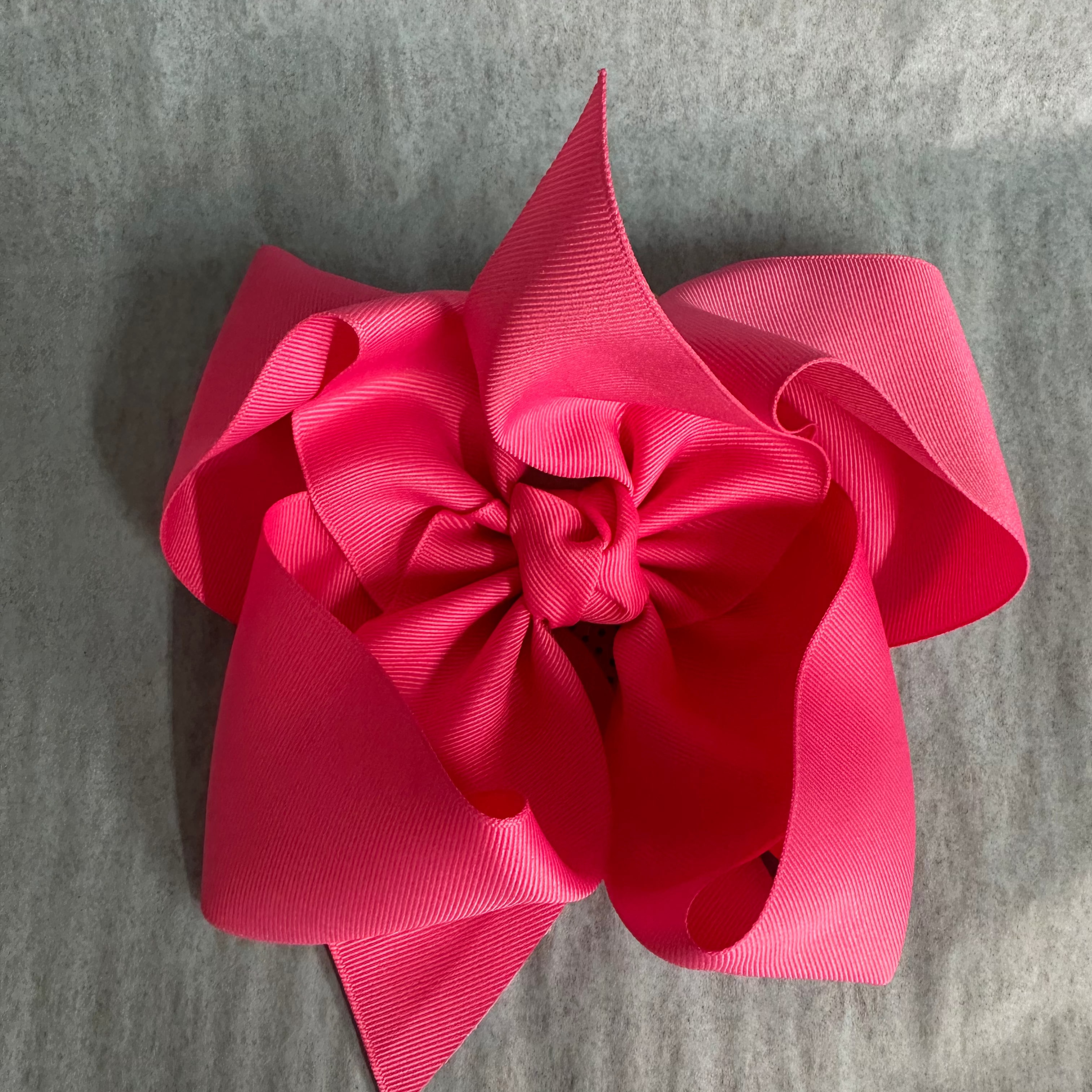 Pink bow on a gray textured background