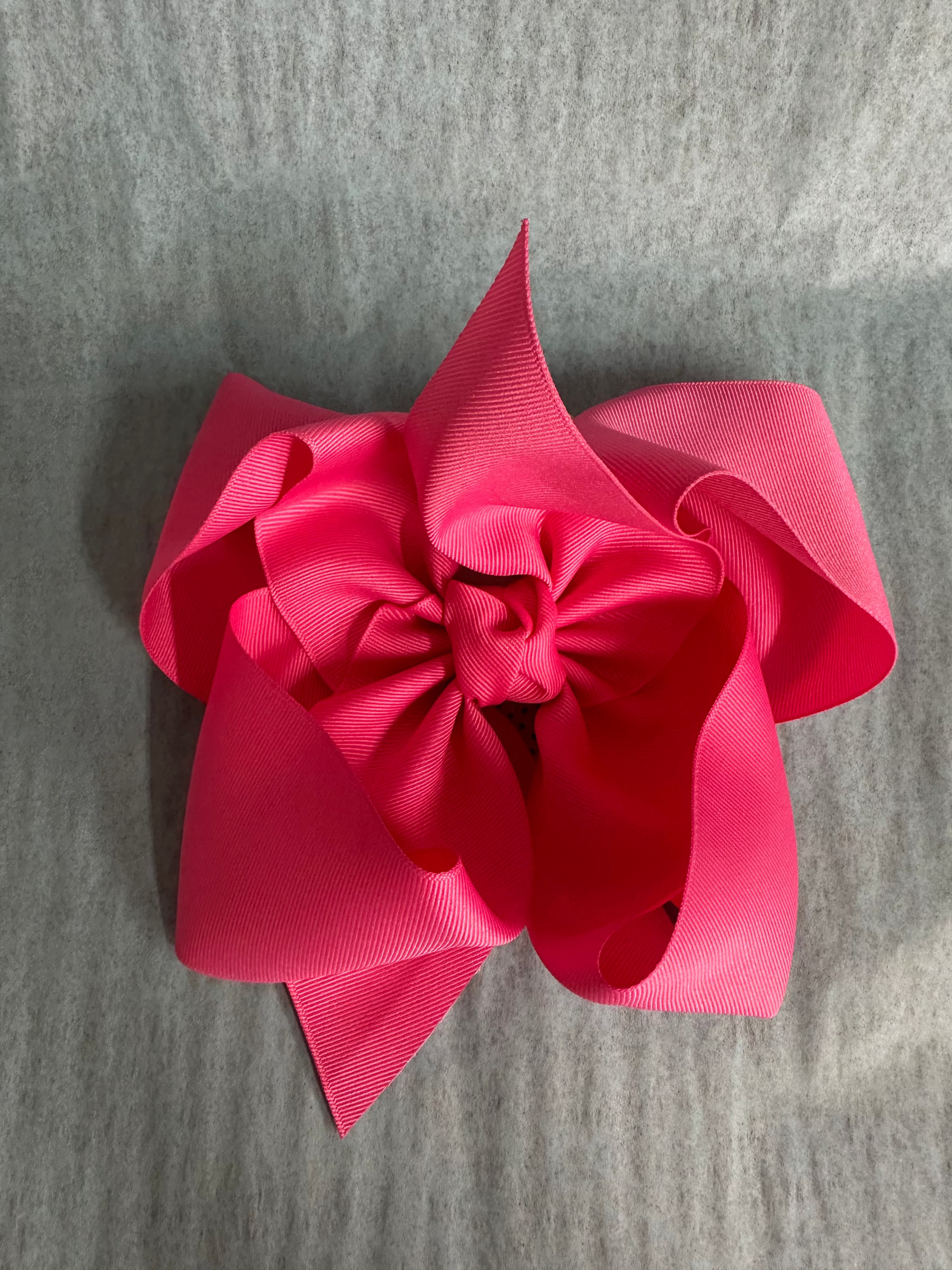 Pink bow on a gray textured background