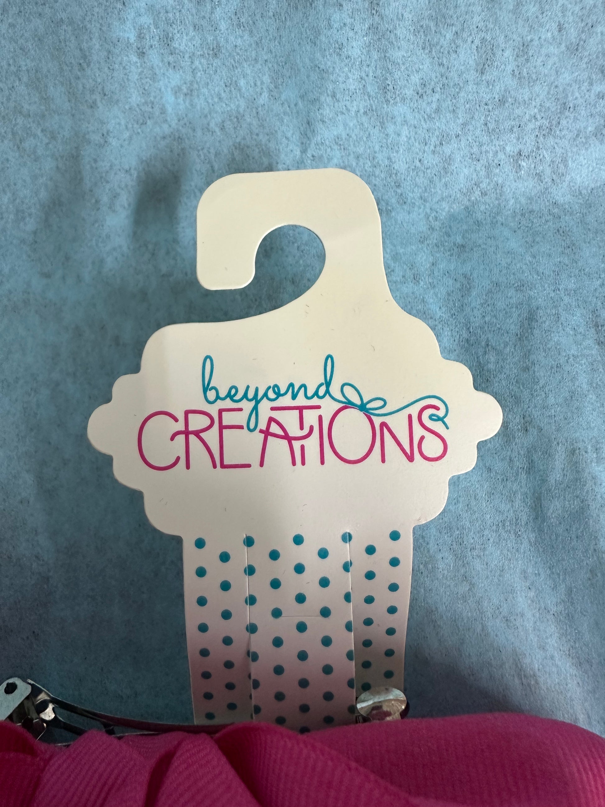 Hanging display card with 'beyond Creations' text on a blue background