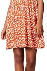 Woman wearing a floral dress with ruffled sleeves against a neutral background