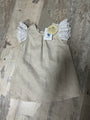 Beige dress with angel wings on a textured surface