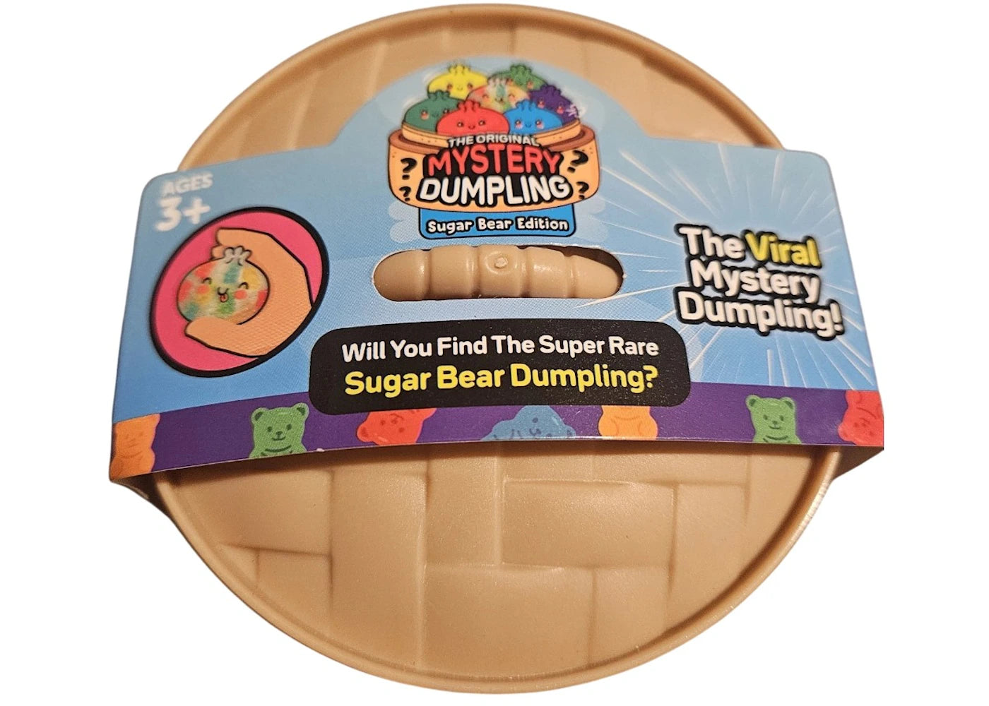 The  Original Mystery Sugar Bear Edition, a beige plastic dumpling inside a blue cardboard packaging sleeve with a clear window.
