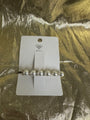 A silver barrette hair clip with five white faux pearls and rhinestone accents, displayed on a white Waffle brand card over a textured gold foil background.