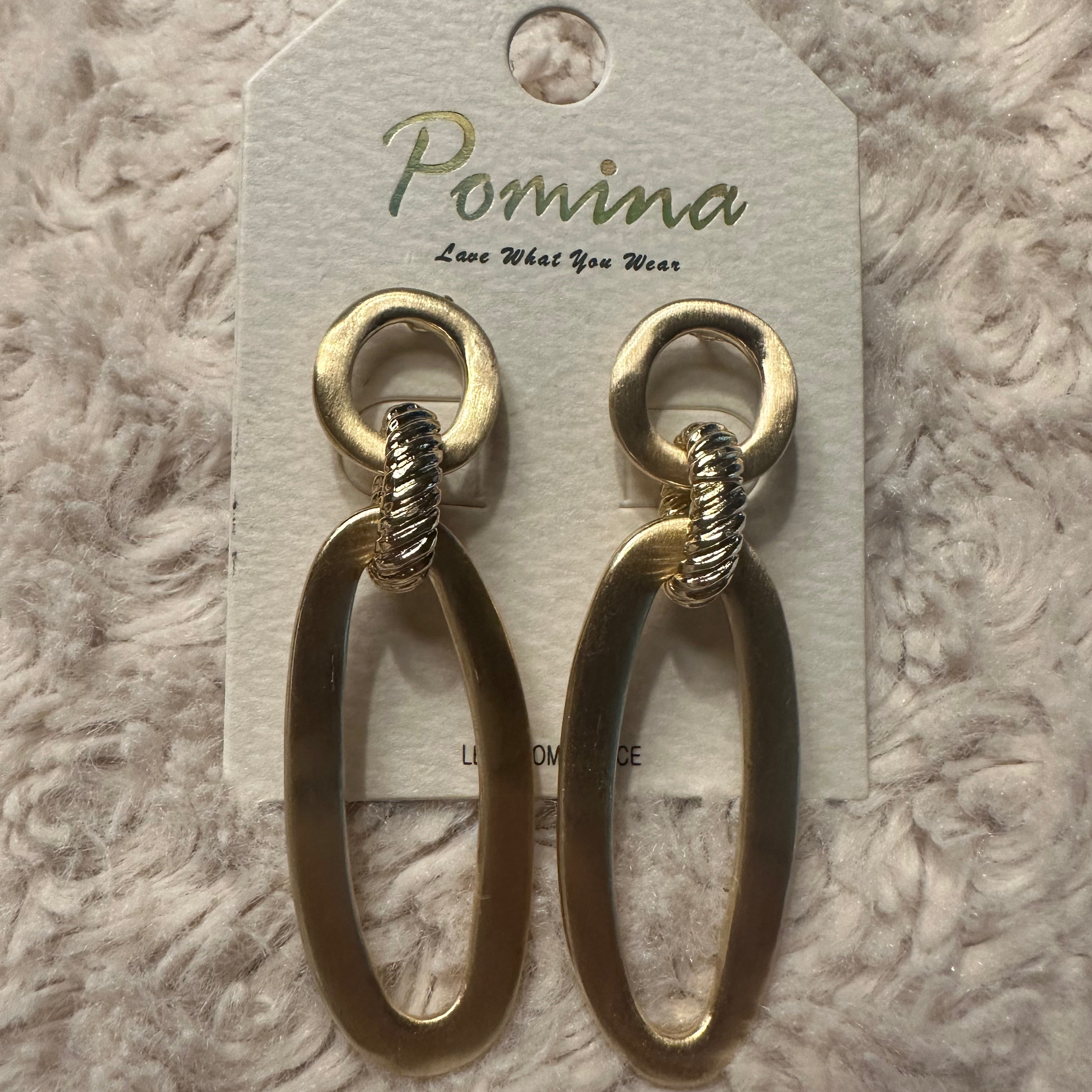 Beautiful gold Pomina post back earrings with circle top and oval bottom on white fluffy background