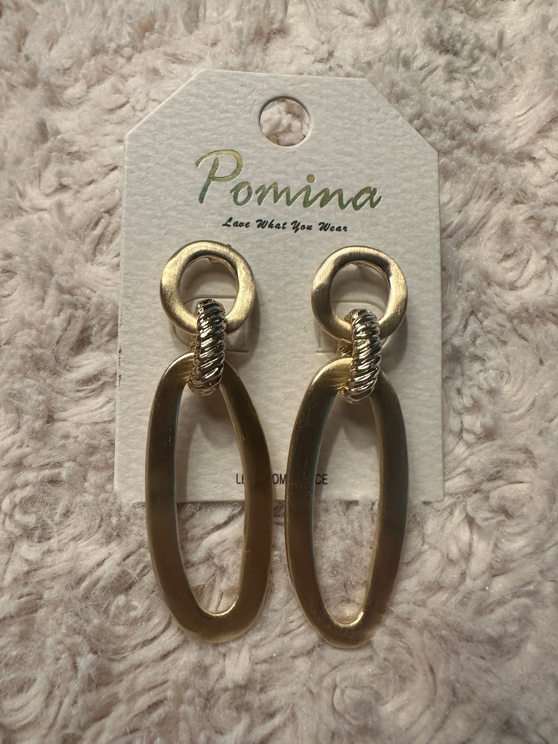Beautiful gold Pomina post back earrings with circle top and oval bottom on white fluffy background