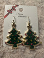 Christmas tree earrings with star on top and red and gold ornaments on white card saying Merry Christmas with red and gold bow