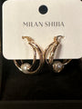 Milan Shijia gold hoop earrings with pearl accents, displayed on a white branded card inside a black presentation box.