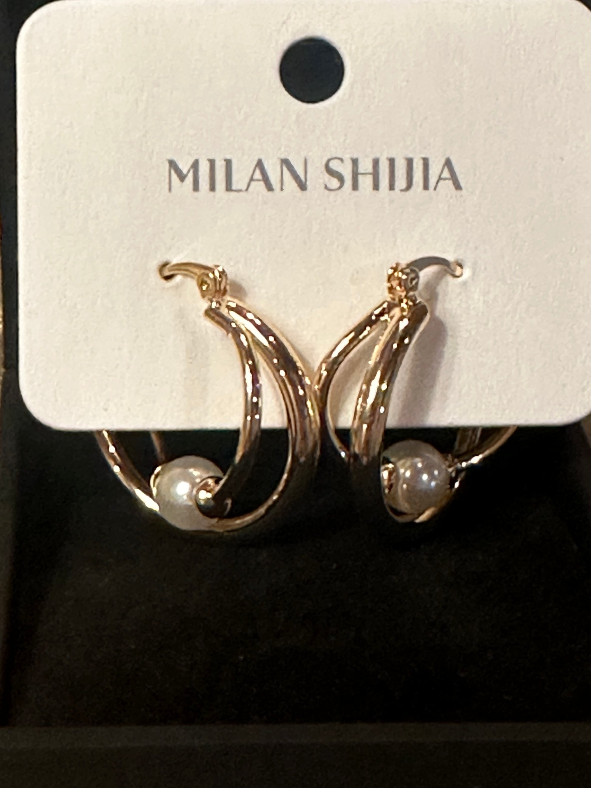 Milan Shijia gold hoop earrings with pearl accents, displayed on a white branded card inside a black presentation box.