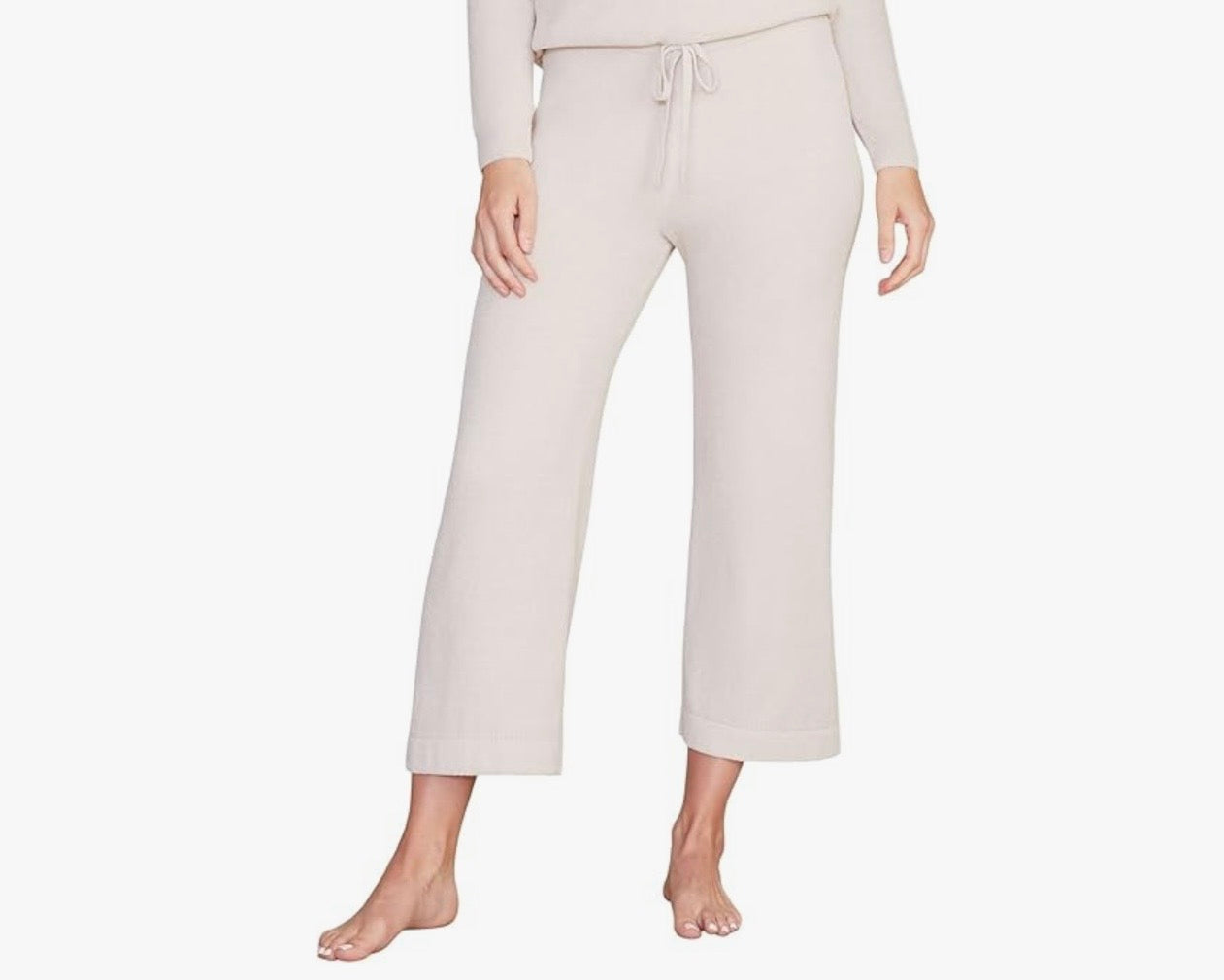 Person wearing light-colored pants on a white background