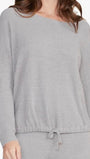 Gray long-sleeve top worn by a person on a white background