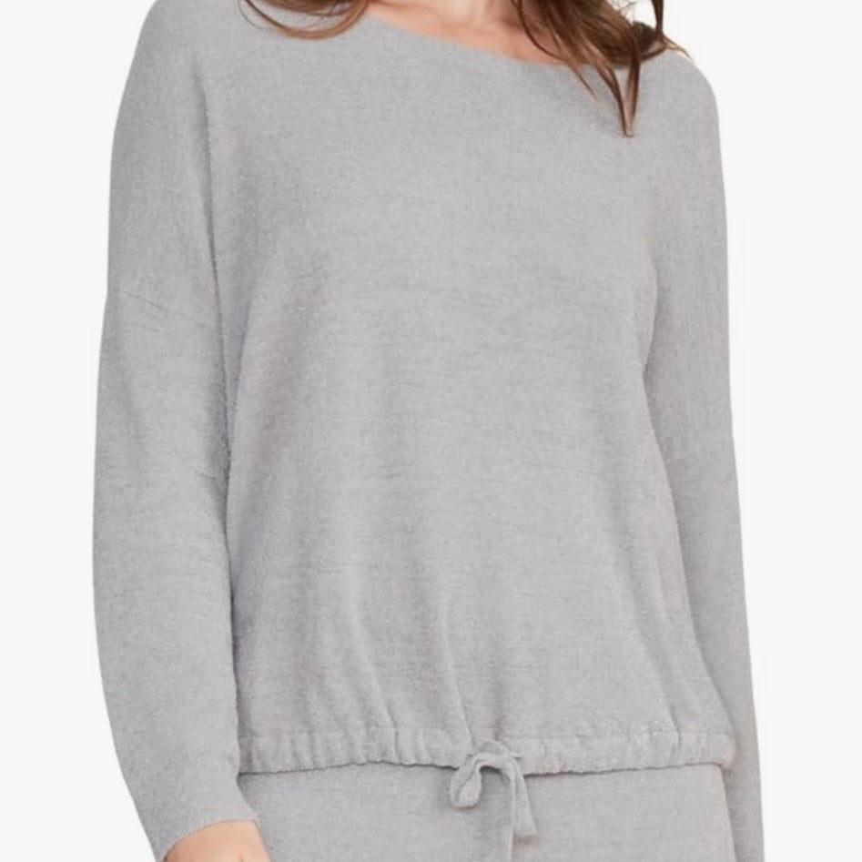 Gray long-sleeve top worn by a person on a white background