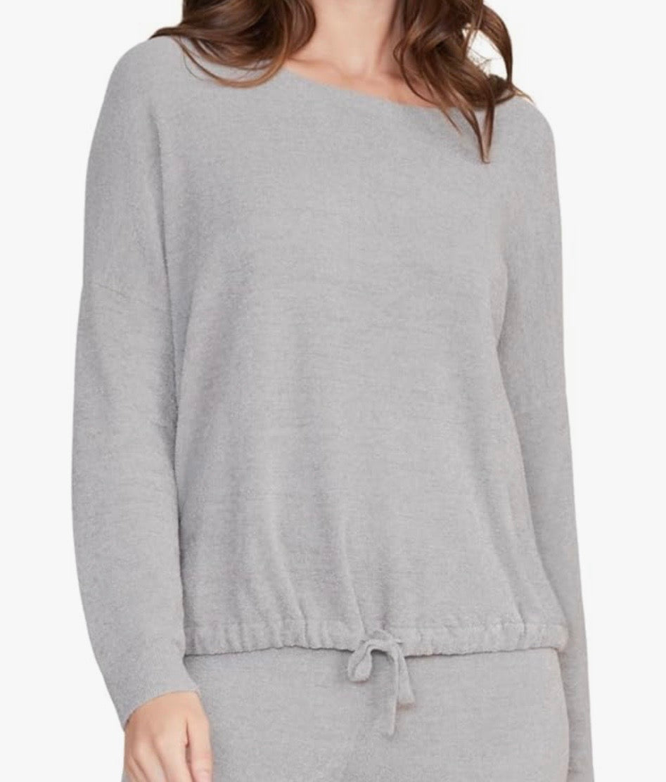 Gray long-sleeve top worn by a person on a white background