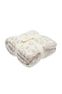 Folded blanket with a subtle pattern on a white background