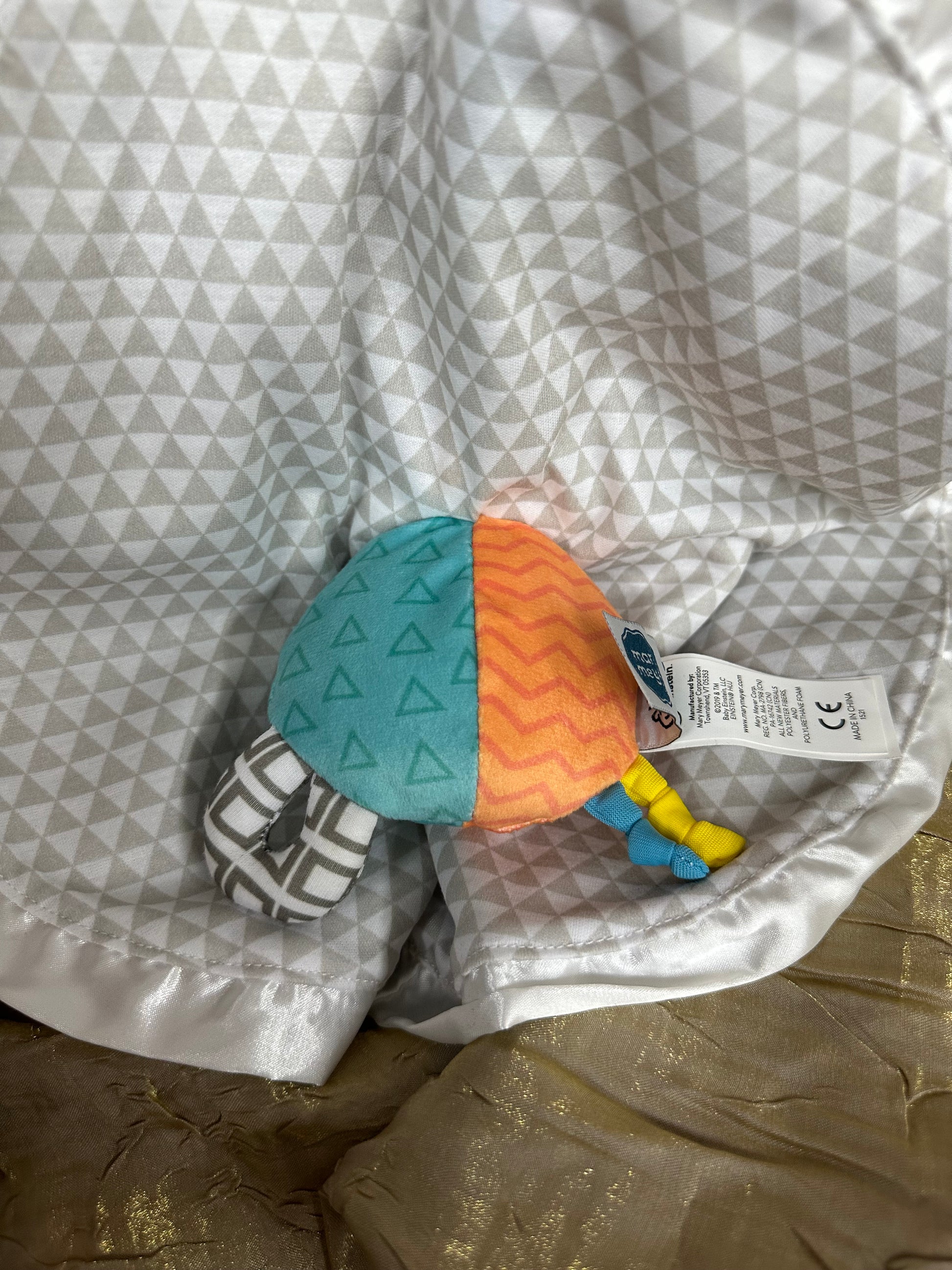 Toy with geometric design on a patterned surface
