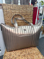 Silver handbag on a textured surface with blurred background