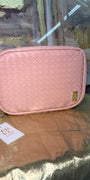Pink pouch with a tag on a reflective surface