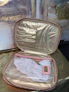 Gold jewelry box with lace fabric on a textured surface