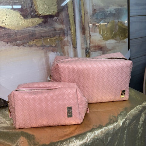 Pink quilted bags on a reflective surface