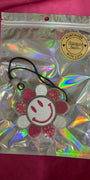 Holographic bag with a decorative item on a pink background