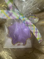 Trinket dish in purple  with a colorful bow on a reflective surface