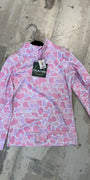 Pink patterned shirt with a brand tag on a concrete floor