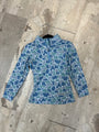 Blue camouflage-patterned jacket on a wooden floor