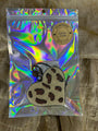 Holographic packaging with a cookie-shaped product on a textured surface