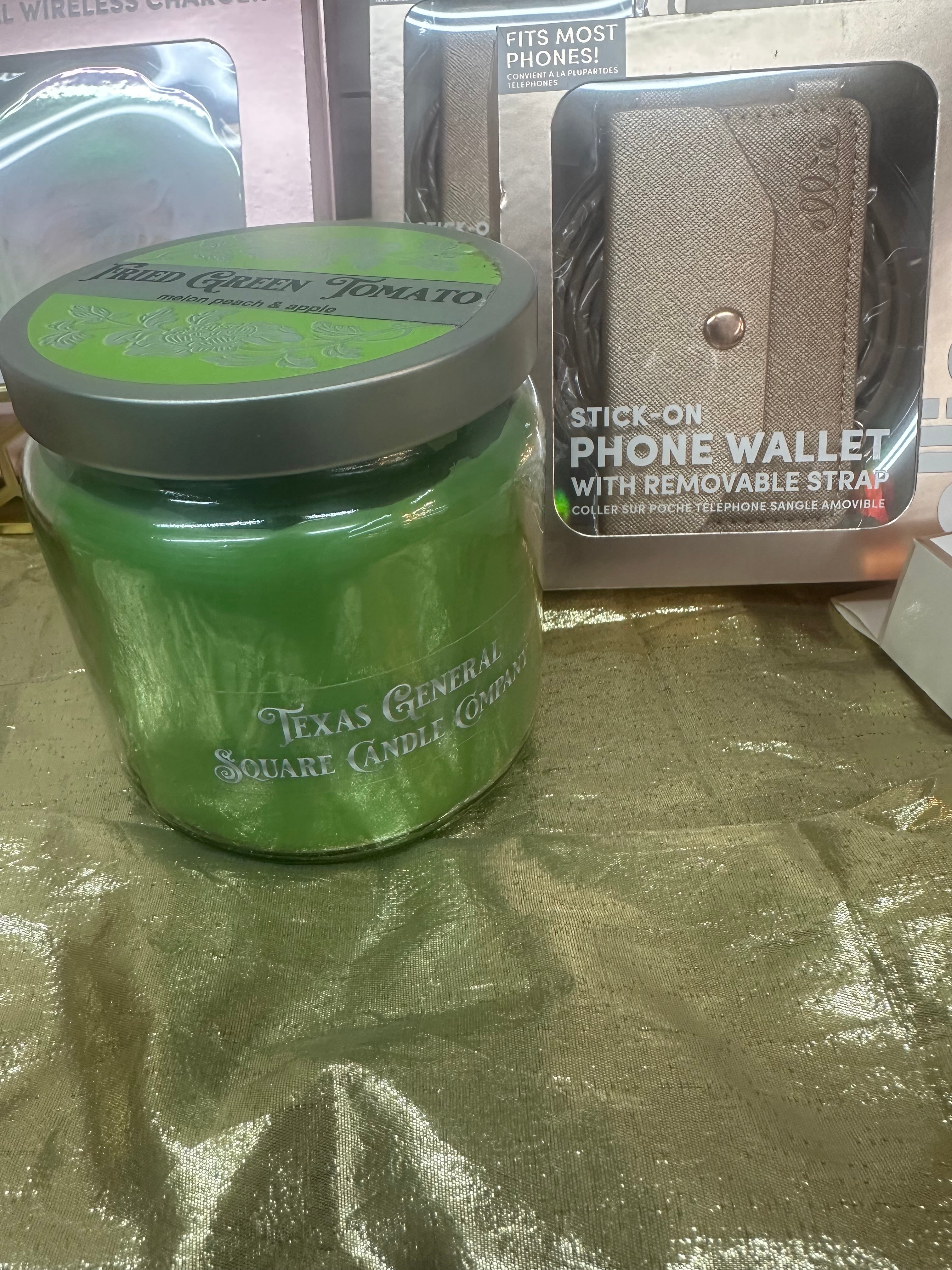 Green jar with a silver lid on a reflective surface