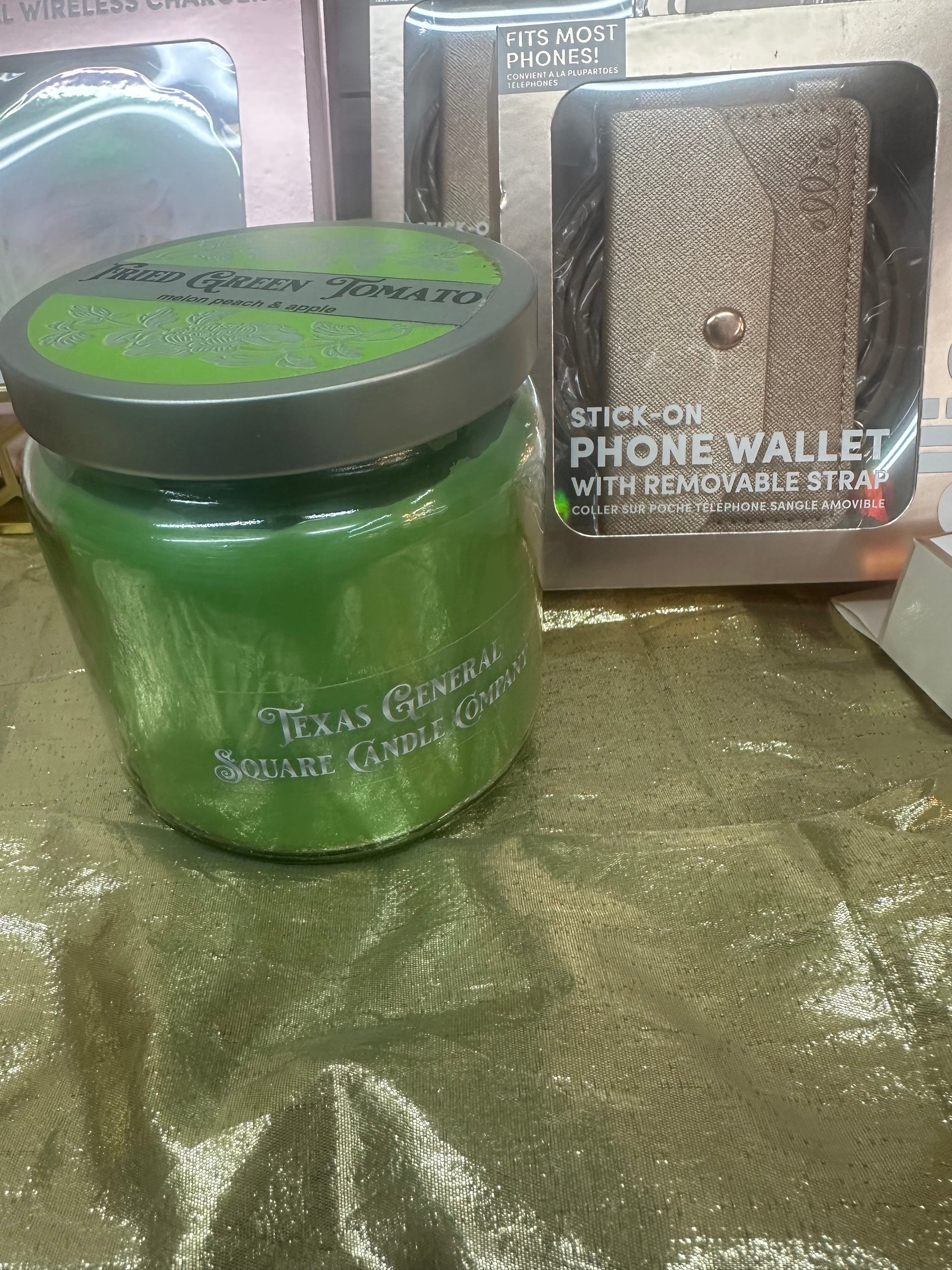 Green jar with a silver lid on a reflective surface