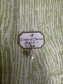 Drops of Charm white gold charm with pearl on green and white background