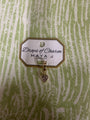 Yellow gold heart charm from Maya J called Drops of Charm on a green and white background