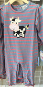 A baby long-sleeve footless romper with horizontal blue-gray and pink stripes, featuring a black-and-white cow applique on the chest, hanging on a wooden hanger on a retail display.