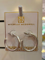Silver hoop earrings on a branded card with 'Michelle McDowell' logo.