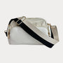 White handbag with black strap on a light gray background