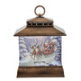 A decorative lantern-shaped Christmas ornament featuring a winter scene with Santa Claus in a sleigh pulled by reindeer, set against a snowy forest. The lantern has a rustic bronze-brown wood-grain frame and a top hanging loop, shown on a plain white background.