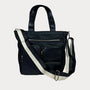 Black handbag with a white strap on a light gray background