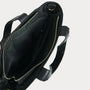 Black bag with gold zipper on a light gray background