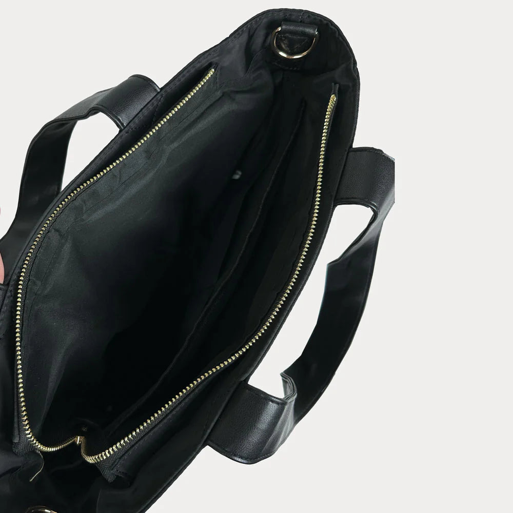 Black bag with gold zipper on a light gray background