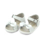 White children's sandals with bow details on a white background